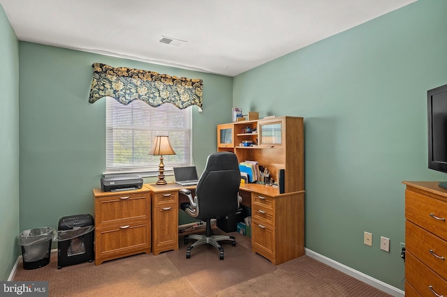 office area with baseboards, visible vents, and light carpet