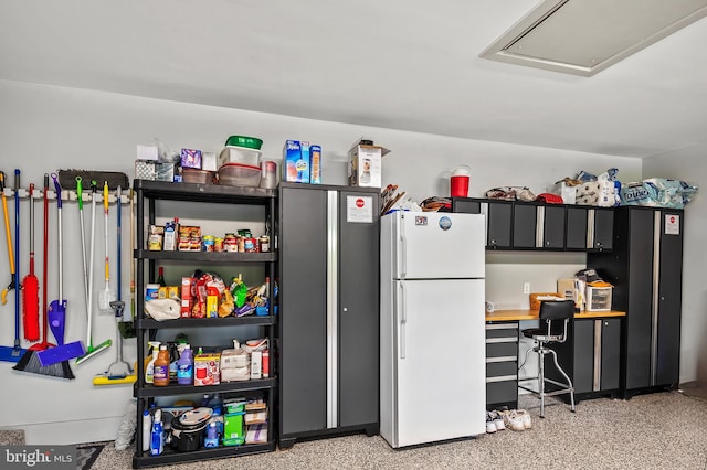 interior space with freestanding refrigerator and light speckled floor