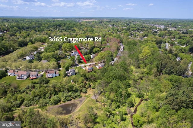 aerial view featuring a wooded view