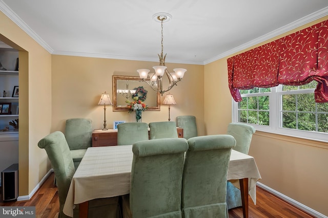 dining space featuring an inviting chandelier, baseboards, crown molding, and wood finished floors
