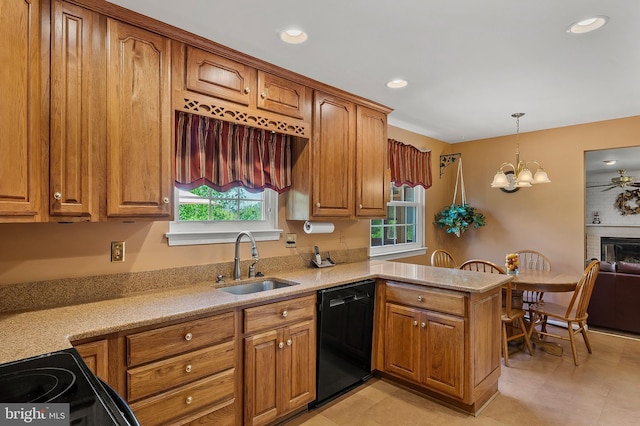 kitchen with a sink, brown cabinetry, black appliances, and a peninsula