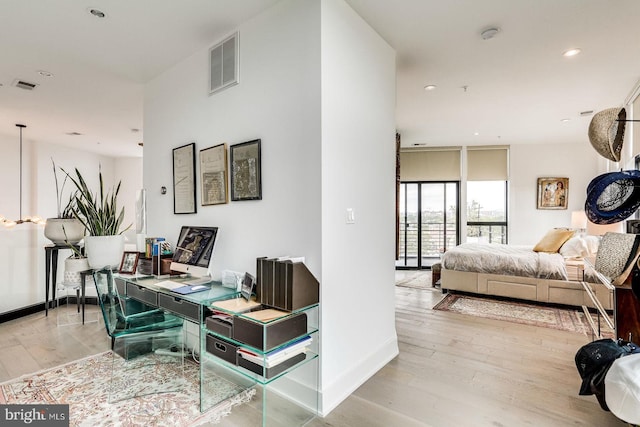 interior space featuring recessed lighting, baseboards, visible vents, and wood finished floors