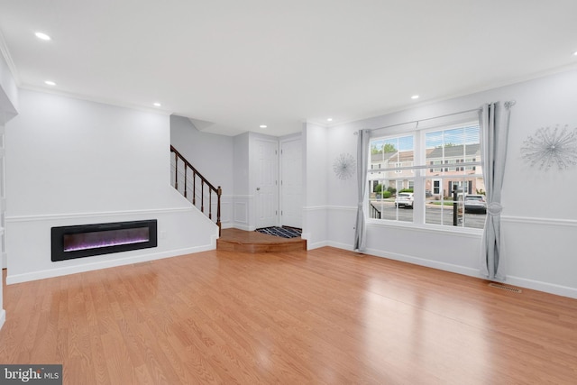 34 Starboard Ct, Gaithersburg, MD 20877 - unfurnished living room with wood finished floors, recessed lighting, a glass covered fireplace, stairway, and baseboards