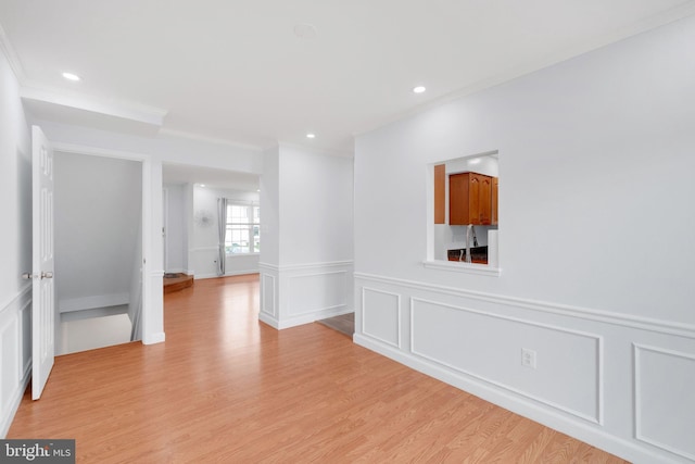 34 Starboard Ct, Gaithersburg, MD 20877 - empty room featuring ornamental molding, a decorative wall, light wood-type flooring, recessed lighting, and wainscoting