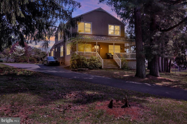 3401 Eisenbrown Rd, Reading, PA 19605 - view of front of home featuring a porch, a standing seam roof, metal roof, stairs, and stucco siding