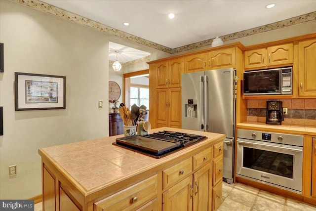 3401 Eisenbrown Rd, Reading, PA 19605 - kitchen with decorative backsplash, a kitchen island, recessed lighting, tile countertops, and appliances with stainless steel finishes