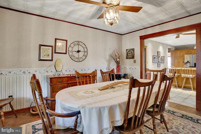 3401 Eisenbrown Rd, Reading, PA 19605 - dining area with crown molding, a wainscoted wall, and a ceiling fan