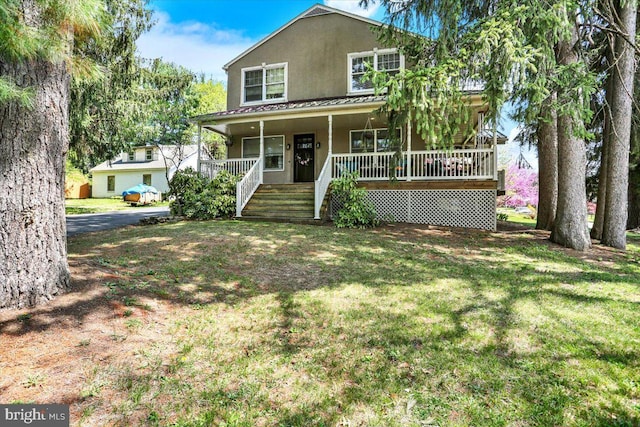 3401 Eisenbrown Rd, Reading, PA 19605 - view of front of house featuring a porch, metal roof, a front yard, and stucco siding