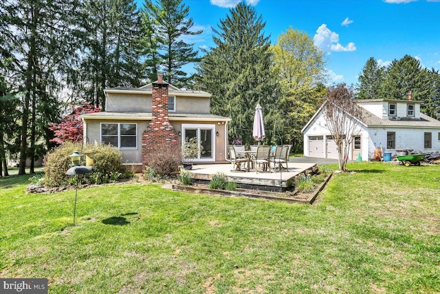 3401 Eisenbrown Rd, Reading, PA 19605 - back of property with a yard, stucco siding, a chimney, and a garage