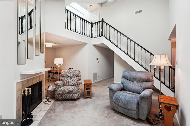 12116 Greenway Ct Unit 302, Fairfax, VA 22033 - living room with a towering ceiling, visible vents, a fireplace, stairway, and carpet