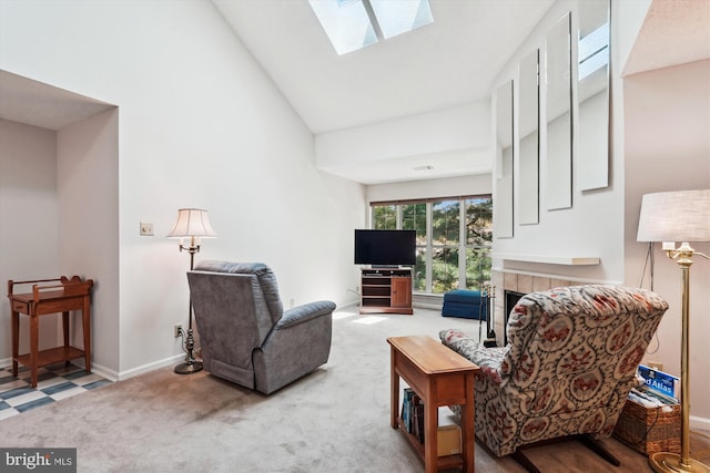 12116 Greenway Ct Unit 302, Fairfax, VA 22033 - carpeted living area featuring baseboards, a skylight, a tiled fireplace, and high vaulted ceiling