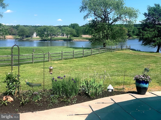 view of yard with a water view and fence
