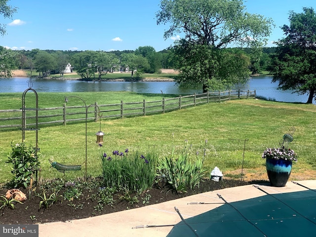 view of yard with fence and a water view