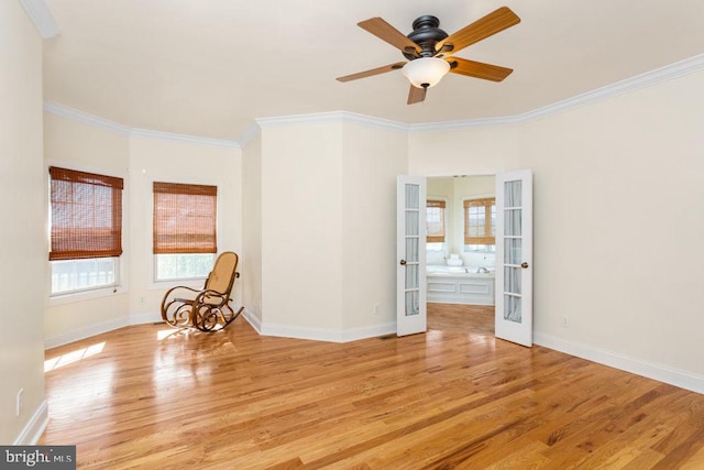 unfurnished room with french doors, a ceiling fan, baseboards, light wood-type flooring, and ornamental molding