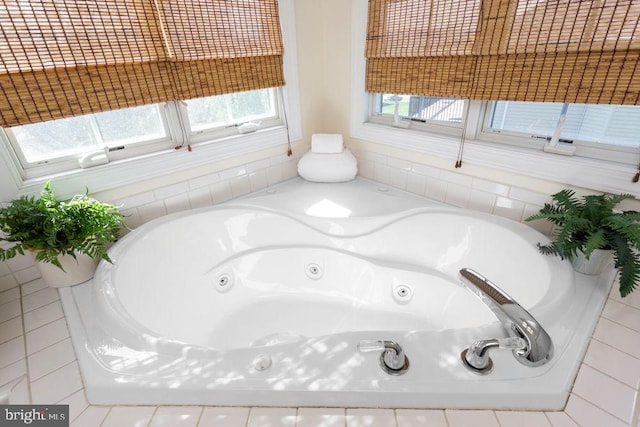 bathroom featuring a jetted tub and plenty of natural light