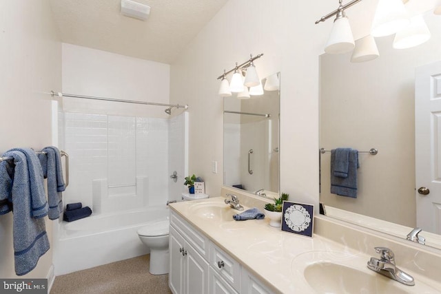 bathroom with a sink, toilet, double vanity, and shower / washtub combination