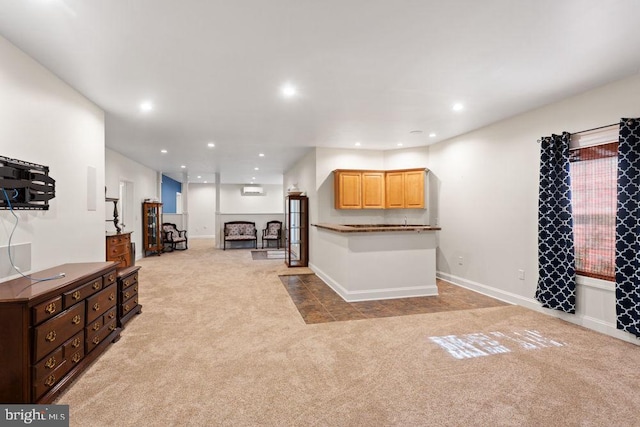 living area featuring a fireplace, baseboards, light carpet, and recessed lighting