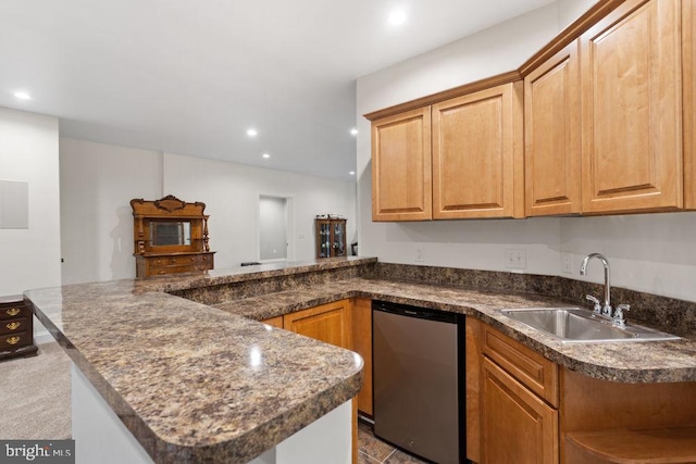 kitchen featuring dark countertops, a sink, dishwasher, a peninsula, and recessed lighting