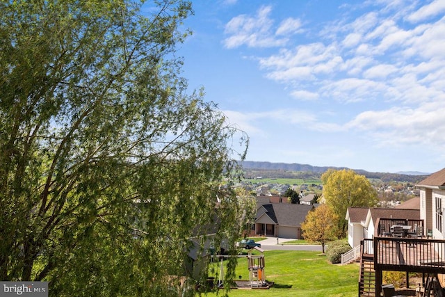 view of yard featuring a residential view, a wooden deck, and stairway