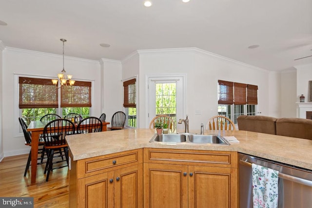 kitchen featuring stainless steel dishwasher, a sink, light countertops, a chandelier, and light wood-style floors