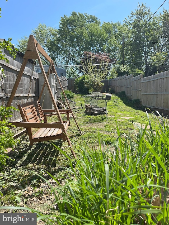 view of yard with a fenced backyard and an outdoor structure