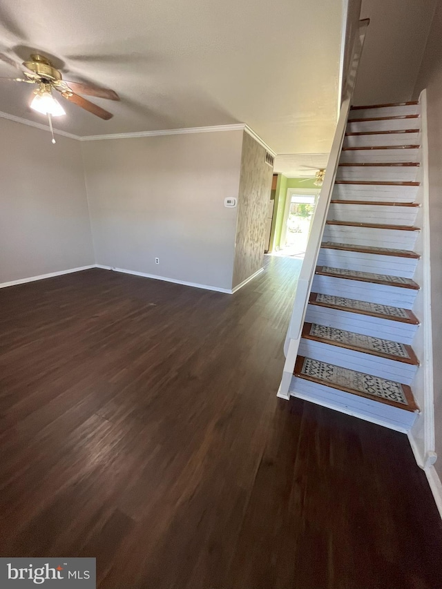 stairway with crown molding, baseboards, a ceiling fan, and wood finished floors