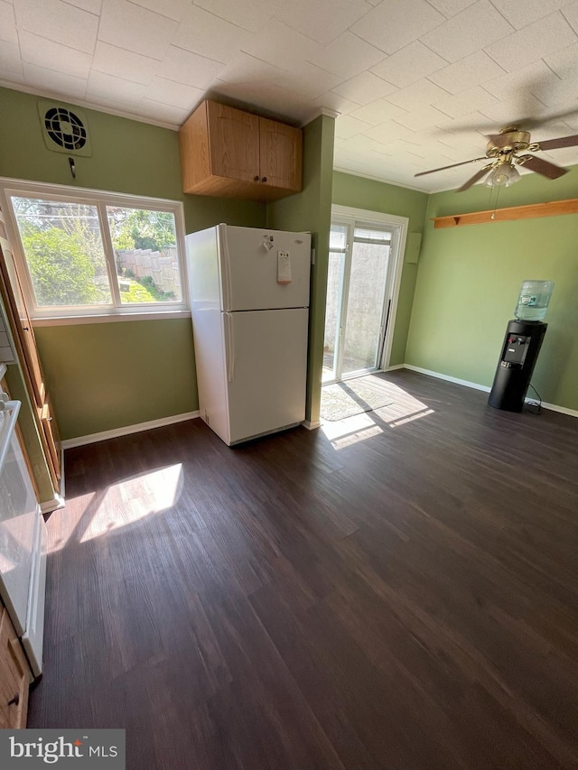 unfurnished living room with baseboards, a ceiling fan, and dark wood-type flooring