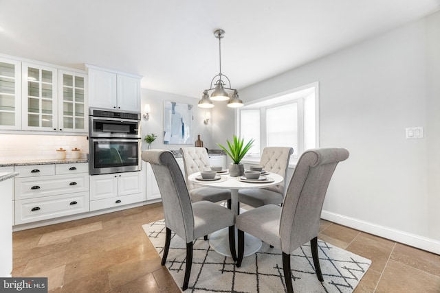 dining space featuring baseboards