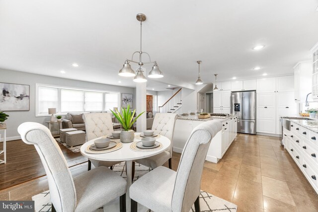dining room featuring recessed lighting, baseboards, and stairway