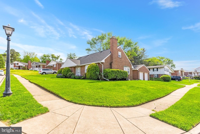 view of side of home with a yard, brick siding, a residential view, and a detached garage
