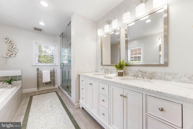 bathroom featuring a sink, double vanity, recessed lighting, visible vents, and a stall shower