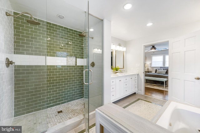 bathroom featuring double vanity, ceiling fan, recessed lighting, ensuite bath, and tiled shower