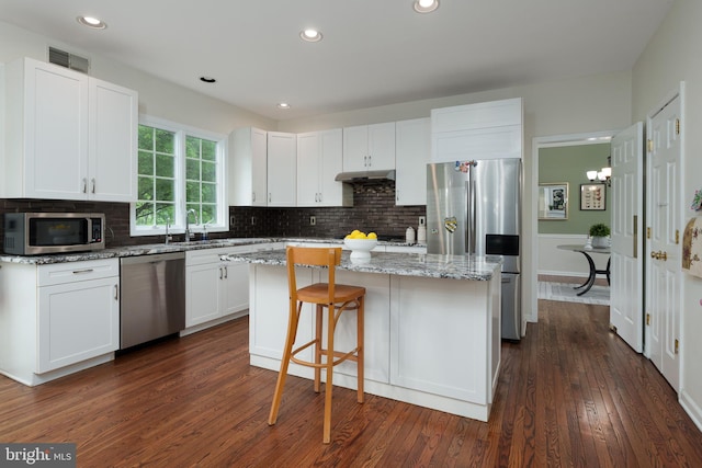 3 Firestone Ct, Skillman, NJ 08558 - kitchen featuring stainless steel appliances, under cabinet range hood, a sink, a center island, and white cabinetry