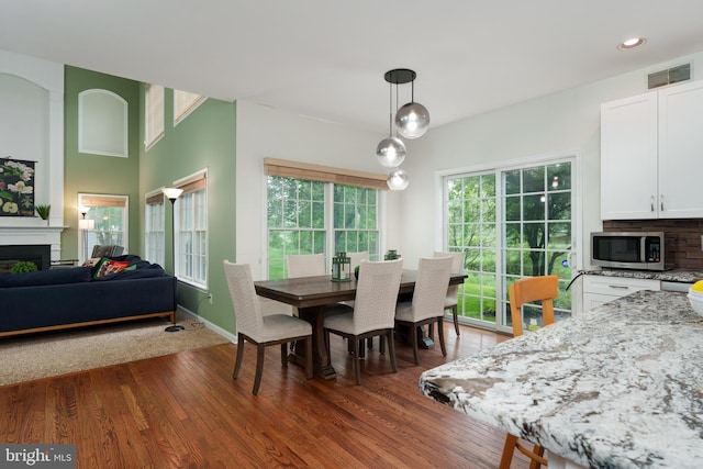 3 Firestone Ct, Skillman, NJ 08558 - dining area featuring a fireplace, dark wood-type flooring, recessed lighting, and baseboards