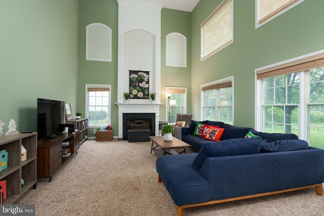 3 Firestone Ct, Skillman, NJ 08558 - carpeted living area featuring a towering ceiling and a glass covered fireplace