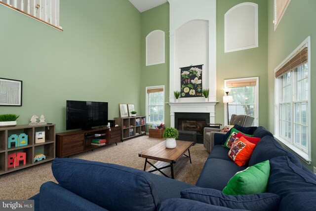 3 Firestone Ct, Skillman, NJ 08558 - carpeted living room featuring a high ceiling and a fireplace