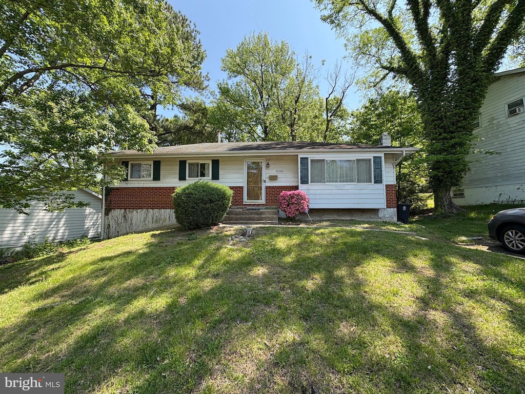 5604 Dundalk Dr, Oxon Hill, MD 20745 - ranch-style home with brick siding, a chimney, and a front yard