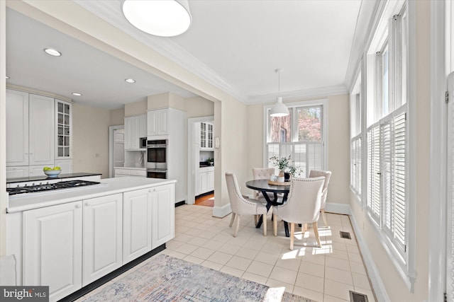 kitchen with glass insert cabinets, baseboards, light tile patterned floors, and white gas stovetop