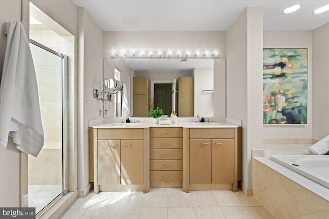 full bathroom with a sink, a garden tub, a stall shower, and double vanity