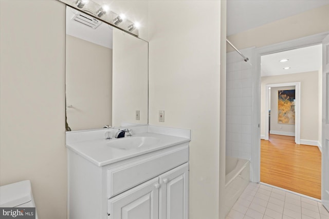 bathroom featuring visible vents, shower / washtub combination, tile patterned floors, vanity, and toilet