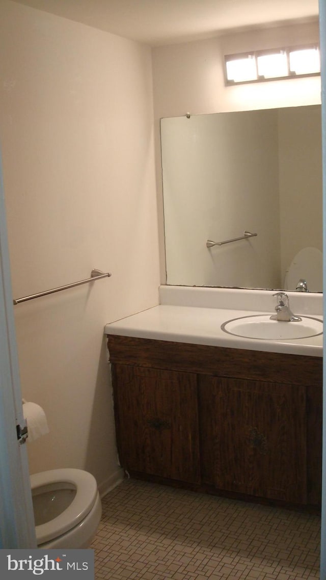 bathroom featuring vanity and toilet