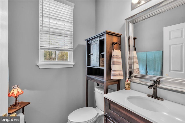 bathroom featuring toilet and vanity