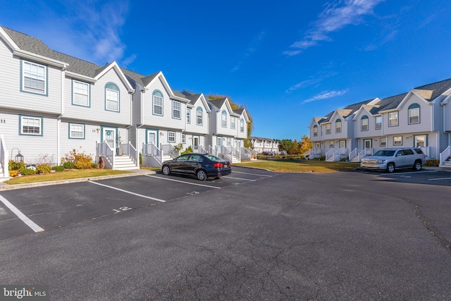 uncovered parking lot featuring a residential view