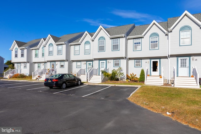 view of front of property with uncovered parking and a residential view
