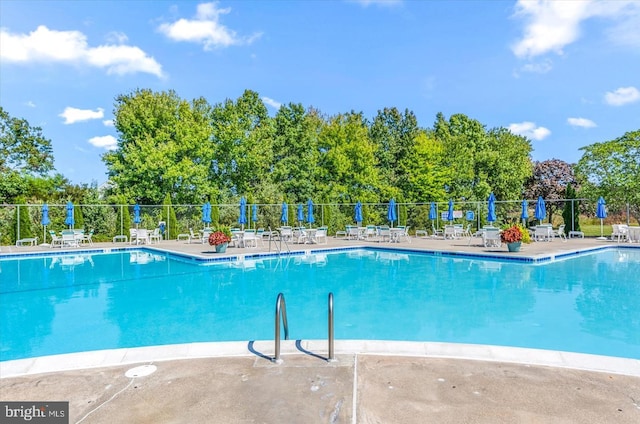 community pool featuring a patio and fence
