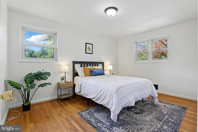 bedroom featuring baseboards and wood finished floors