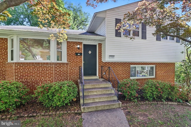 tri-level home with brick siding