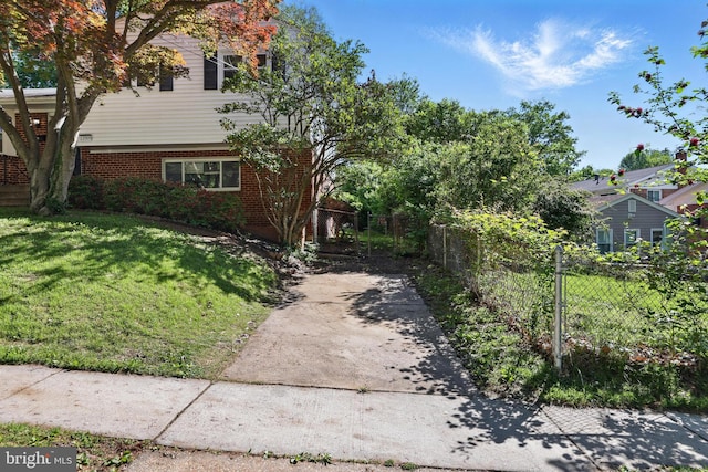 view of property exterior featuring concrete driveway and brick siding