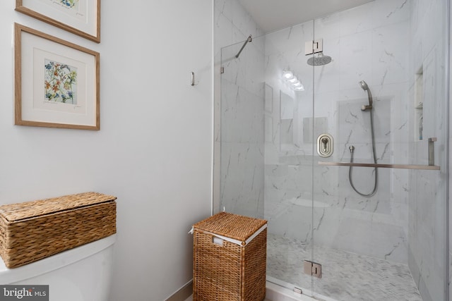 full bathroom featuring toilet and a marble finish shower