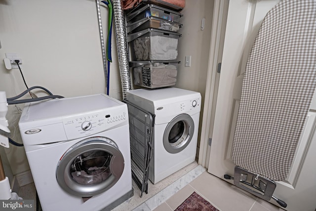 laundry room featuring separate washer and dryer and laundry area